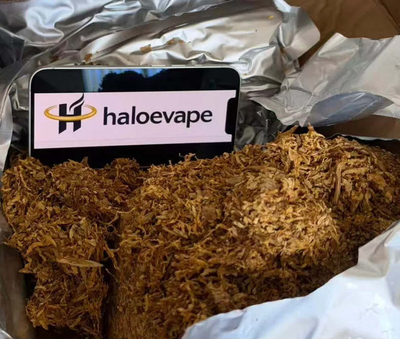 Loose leaf rolling tobacco in a foil bag at Halo E-Vape Australian warehouse with haloevape.com on screen